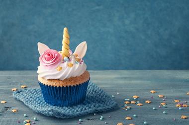 A unicorn cupcake with frosting and decorations