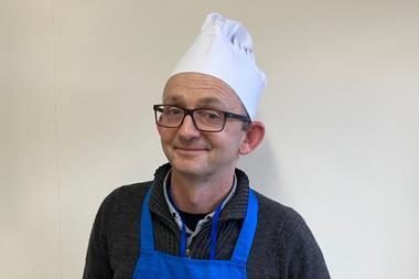 Leighton Byrom, a master baker in blue apron and white hat, at Genius Foods