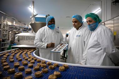 Workers at Wrights factory in Crewe watch the new cookie line