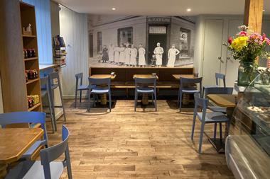 Alexander Taylor - A black and white photo of the bakery displayed on the wall of the cafe  - 2100x1400