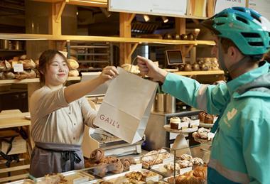 A Deliveroo rider picking up a bag from Gail's