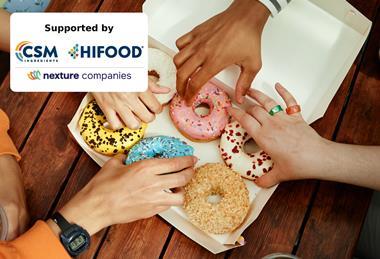 Teenagers taking doughnuts from a box
