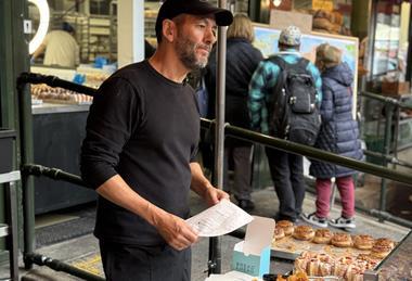 Bread Ahead - Founder Matthew Jones at the streetside doughnut kiosk of his flagship store at Borough Market
