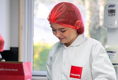 Lily-Anna Barclay weighing out ingredients in a Macphie branded baker's jacket