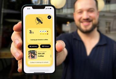 Embargo - Man displays phone with Blackbird Bakery app - 2100x1400