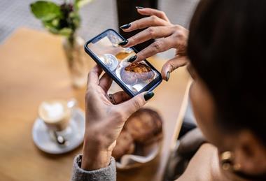 Woman taking photo of baked goods
