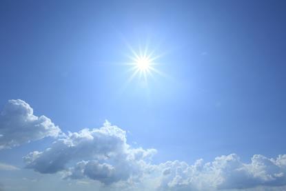 Sun high in a blue sky