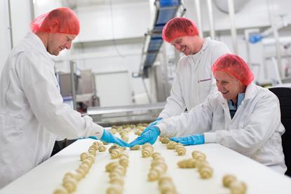 Vandemoortele - Workers at a croissant production line run by Vandemoortele