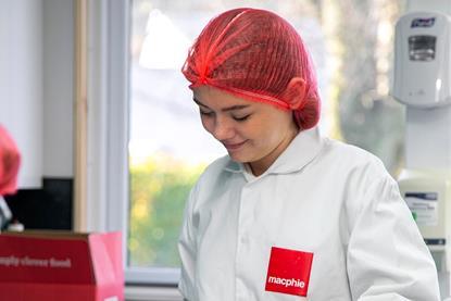 Lily-Anna Barclay weighing out ingredients in a Macphie branded baker's jacket