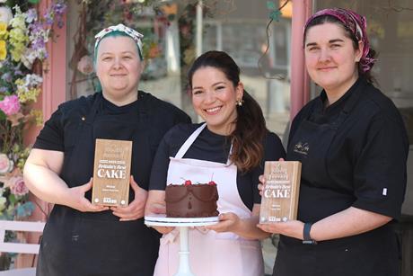 Abba Cakes - Founder Laura Alejandra (centre) showcases The Chocolate Cake with staff members holding Britain's Best Cake 2025 trophies -  2100x1400