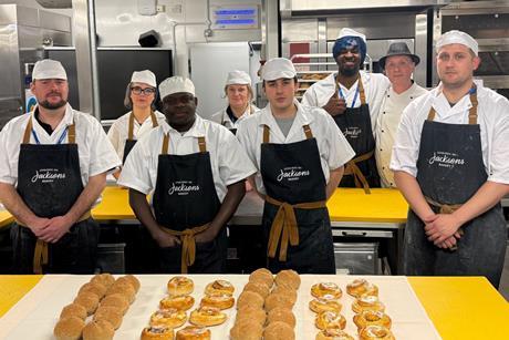 Jacksons Bakery apprentices at The Sheffield College standing in aprons in front of buns