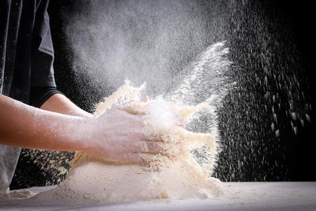 A pile of flour being clapped by a baker