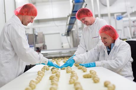 Vandemoortele - Workers at a croissant production line run by Vandemoortele