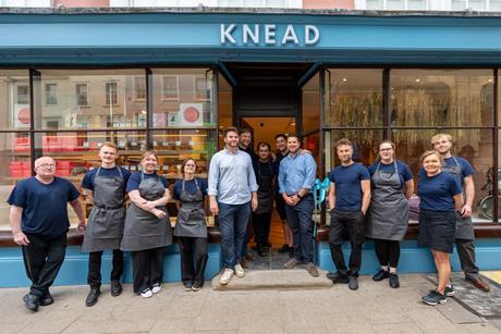 Knead Bakery - Co-founders John Hawes and Kris Biggs (centre in shirts) join staff members outside the new Oxford bakery shop - 2100x1400