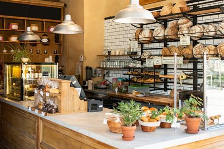 Inside a lovely looking bakery with loaves stacked on the walls