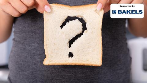 A woman holding a slice of white bread with a question mark-shaped hole in it