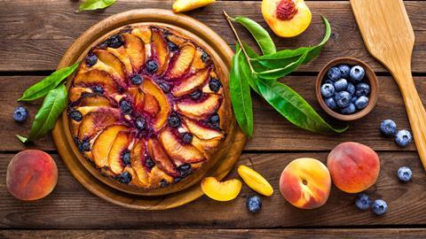 A lovely looking peach & blueberry tart on a wooden board