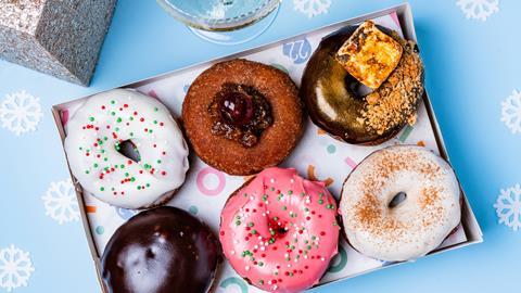 A festive doughnut box filled with six delicious looking doughnuts