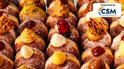 Rows of fried sugared doughnuts with fillings oozing out the top