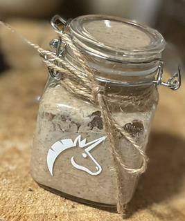 A rye sourdough in a small glass jar with twine