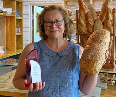Helen O'Connell from Flourish Craft Bakery with the Britain's Best Loaf trophy and category winning loaf