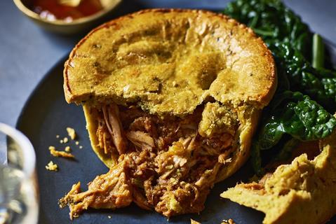 A turkey curry pie with turkey spilling out