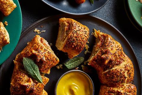 Sausage roll wreath with sage leaves and a mustard dipping sauce