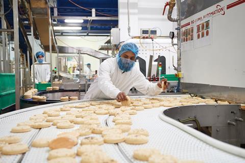 A worker checks wraps on a production line at Signature Flatbreads