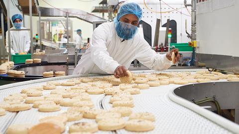 A worker checks wraps on a production line at Signature Flatbreads