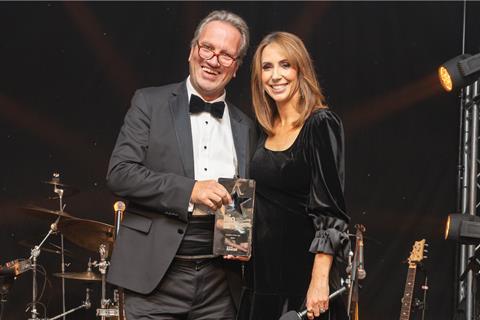 Bako CEO Mike Tully takes another turn on the stage, this time to collect the Supplier of the Year trophy from presenter Alex Jones