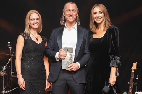 Ed Lees takes to the stage for a second time to collect the Sustainability Initiative of the Year trophy from Yvette Wild, head of retail, bakery & OTG at category sponsor Macphie and Alex Jones