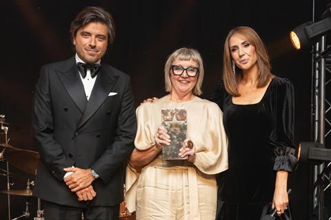 Lisa Smith, owner of Ginger Bakers, collects the Team of the Year trophy on behalf of everyone back at the bakery in Kendal, Cumbria from Lavazza marketing director Filippo Ferrari and Alex Jones