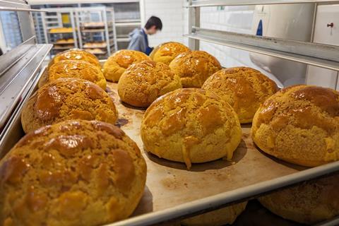 Freshly baked Pineapple Buns prepared in-house at the Newport Place shop of Chinatown Bakery  - British Baker 2100x1400