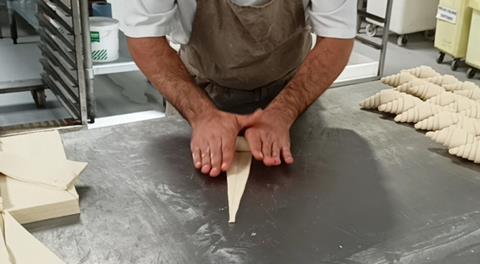 A pastry chef handcrafts croissants at The Cavan Bakery's production site in Walton-on-Thames  2100x1154