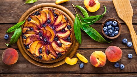 A lovely looking peach & blueberry tart on a wooden board