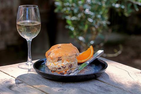 A chocolate chip scone with flecks of orange peel on top