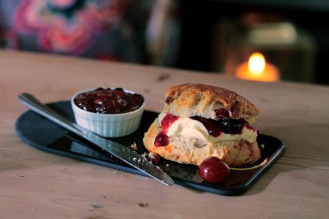 A cherry Bakewell scone loaded with cherry jam and cream in the middle