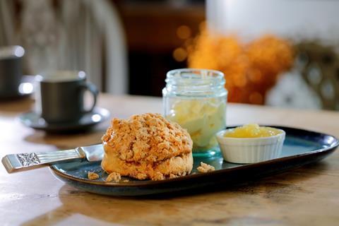 An apple crumb scone topped with apple cinnamon crumble