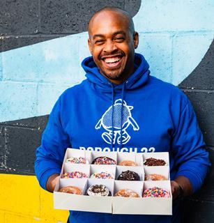 Borough 22 - Founder Ryan Panchoo with a box of doughnuts - 1729x1800