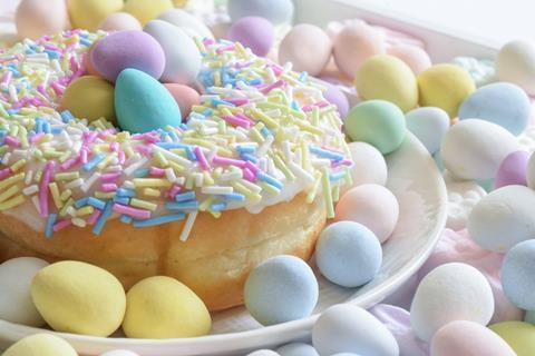 Easter doughnut with pastel sprinkles and mini eggs on top