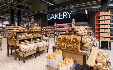 M&S in-store bakery shelves stocked with pretzels, sourdough loaves, and baguettes