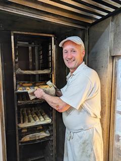 Baker Wayne Hobson, who has worked at Stacey's Bakery for 43 years, puts sausage rolls in the oven  1502x2000