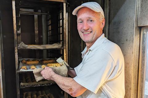 Baker Wayne Hobson, who has worked at Stacey's Bakery for 43 years, puts sausage rolls in the oven  1502x2000