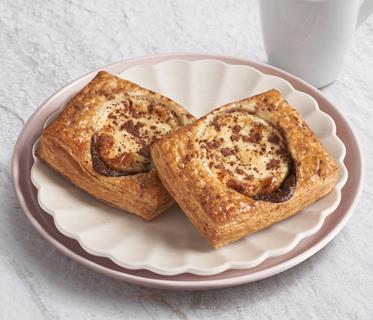 Two Tiramisu Danish pastries on a white plate