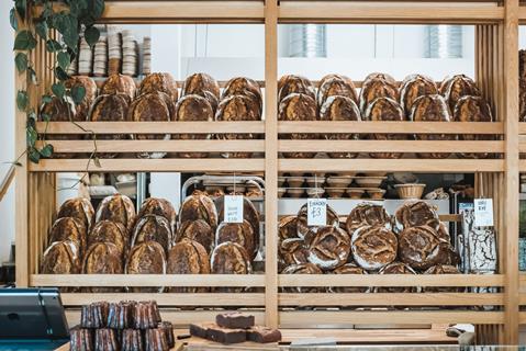 Wooden shelves in artisan bakery Farro loaded with sourdough loaves