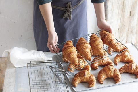 Freshly baked croissants on a rack