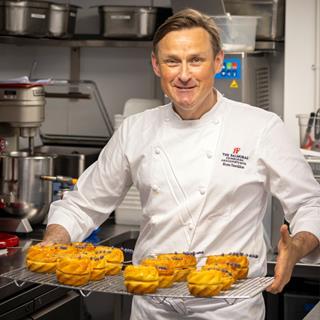 Brown's Hotel - Executive pastry chef Ross Sneddon hold a rack of Mayfair Buns  1080x1080