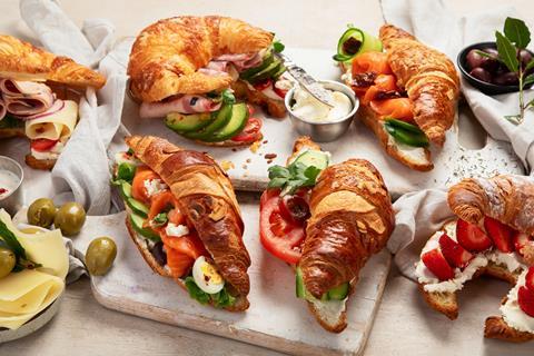 A selection of croissants with savoury fillings like ham, cheese, salmon, cucumber, and tomator