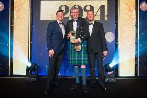 A shocked but happy George Stevenson receives the Outstanding Contribution to the Baking Industry award from Richard Freeman, UK & Ireland commercial director at Délifrance, and celebrity host Scott Mills