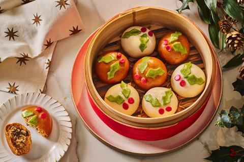 Bao buns, which look like little Christmas puddings, in a steaming basket